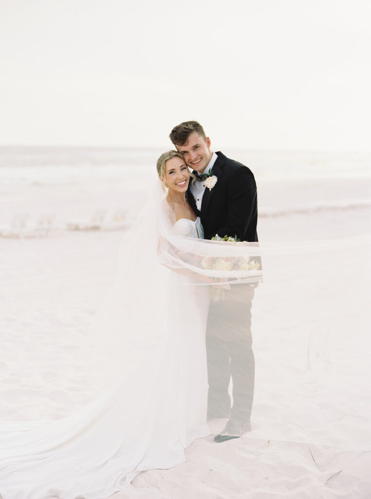 bride and groom posing on the beach at a garden wedding at carillon 