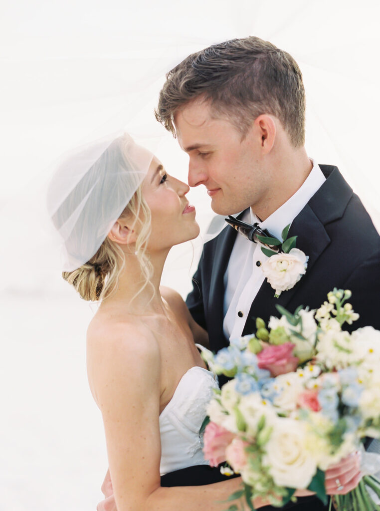 romantic shot of the bride and groom on the beach at their garden wedding at carillon 