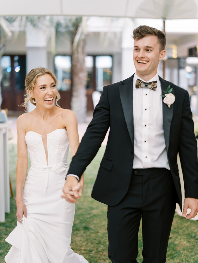 bride and groom walking into reception at garden wedding at carillon 