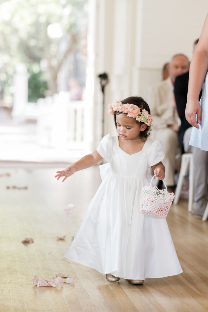 flower girl walking down the aisle at meeting house wedding