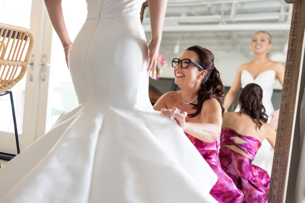 bride getting fitted into her gown at carillon wedding