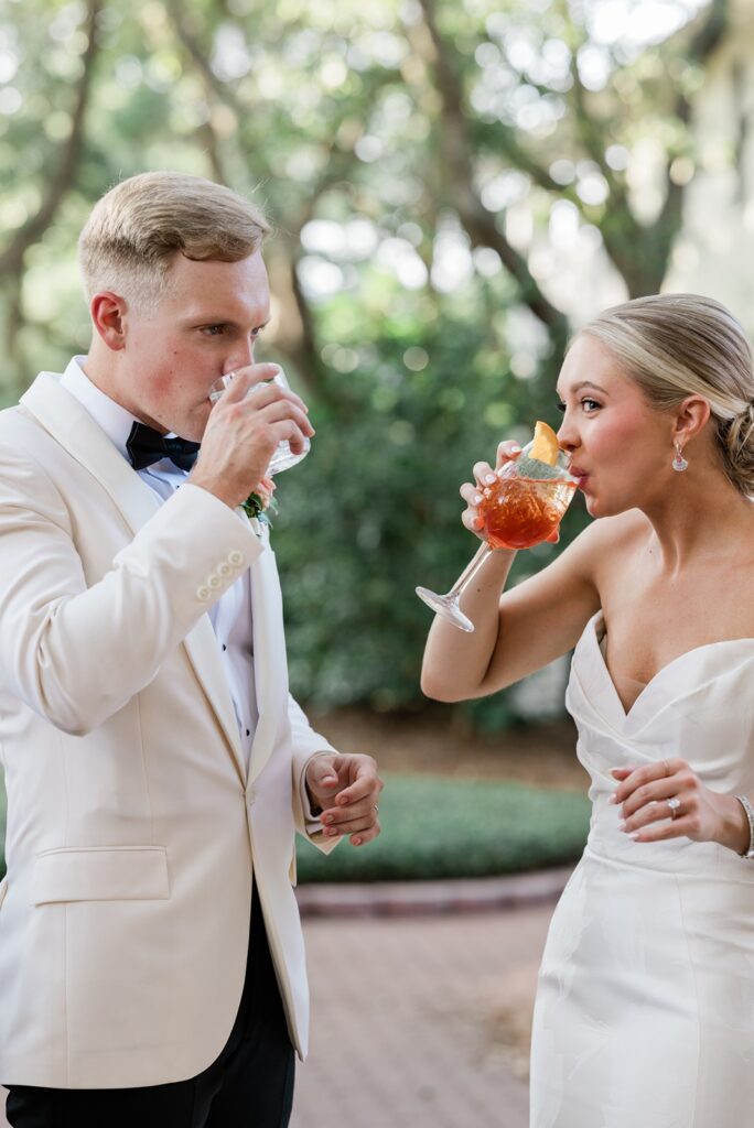 bride and groom taking a drink of there signature cocktails at their 30A wedding in Carillon