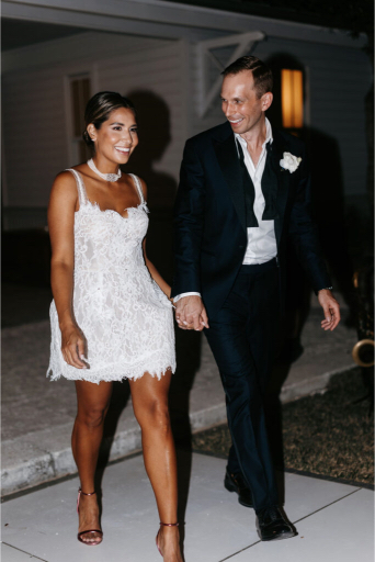 bride and groom make their exit from their wedding at the court