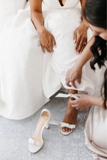 bride getting on her shoes