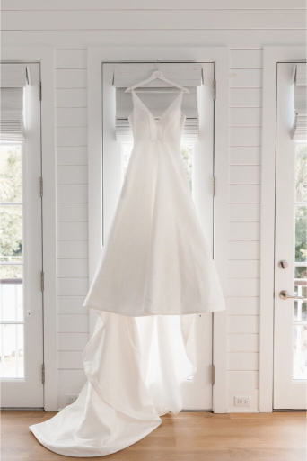 wedding dress hanging in the door way