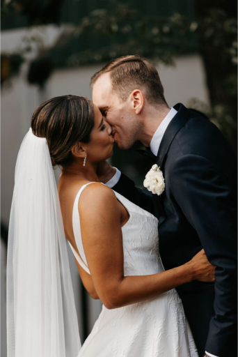 bride and groom kiss for the first time as husband and wife