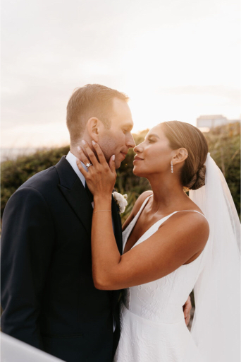 florida bride and groom share in sunset kiss