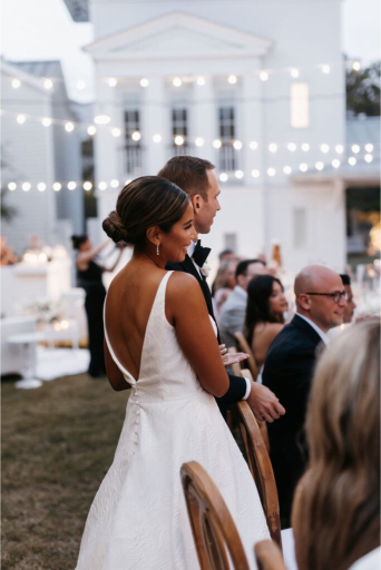 bride and groom arrive at reception at seaside